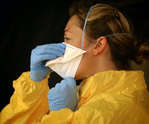 woman wearing yellow personal protective equipment