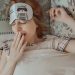 woman yawning with eye mask on face
