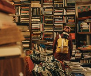 person standing in a cluttered book store