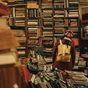 person standing in a cluttered book store