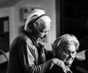 two old women standing near each other looking at the camera