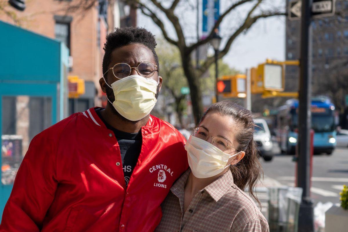 two people smiling with face masks on