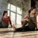 women doing a yoga pose in a yoga studio