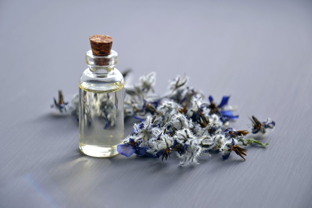 essential oil bottle with a lavender sprig
