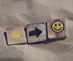 blocks in the sand that are sunshine arrow smiley face