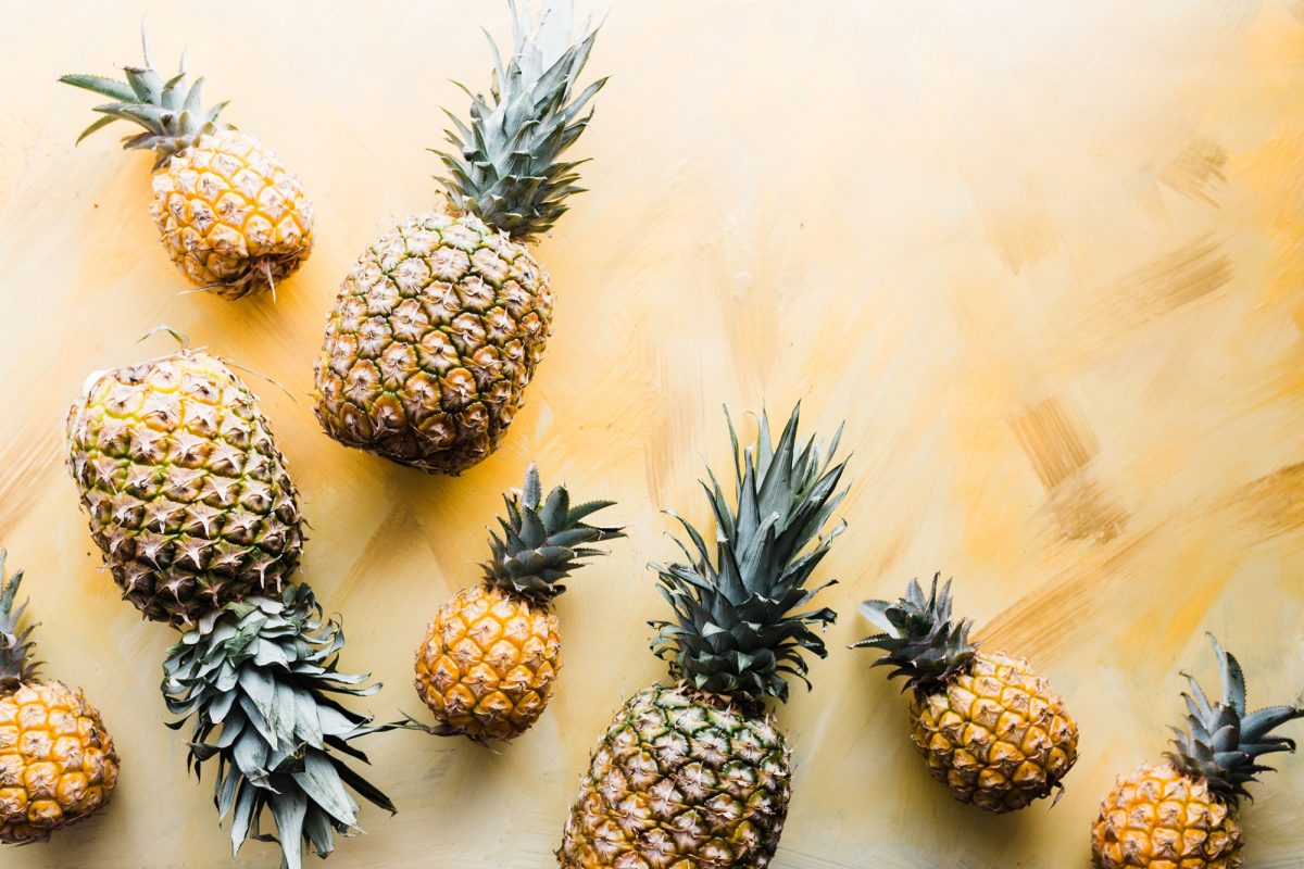 pineapples arranged against a gold surface