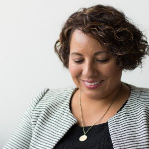 older woman looking down and smiling