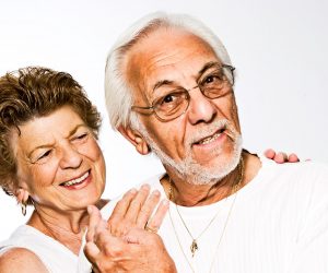 older man and woman posing together