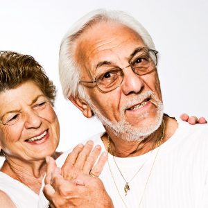 older man and woman posing together