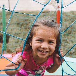 Little girl smiling and playing at the park