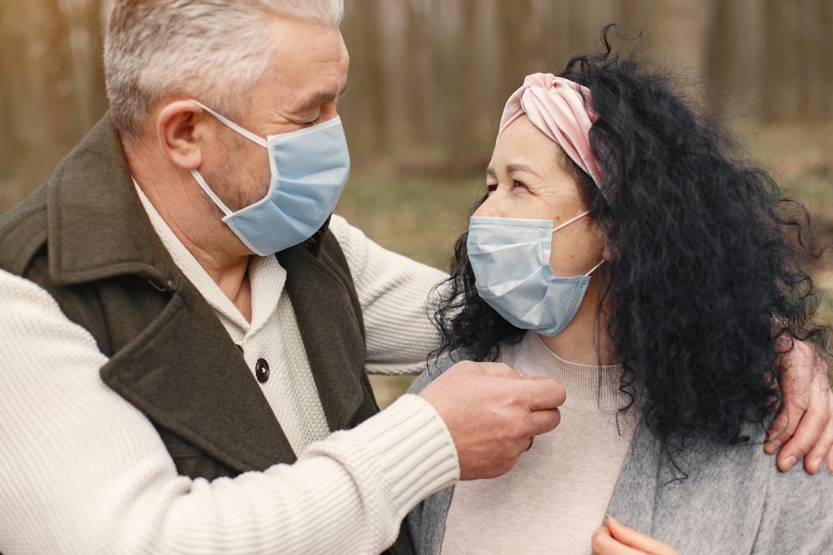 older couple looking at each other with masks on