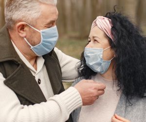 older couple looking at each other with masks on