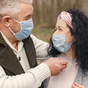 older couple looking at each other with masks on