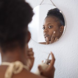 woman putting skin care on her face