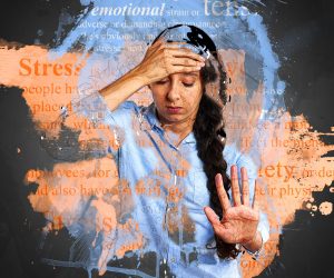 woman holding her head looking stressed