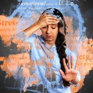 woman holding her head looking stressed