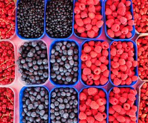 a bunch of mixed berries in trays