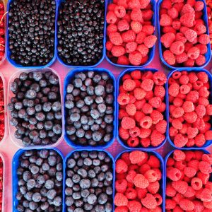 a bunch of mixed berries in trays