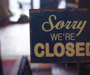 photo of a sign hanging that says Sorry We're Closed
