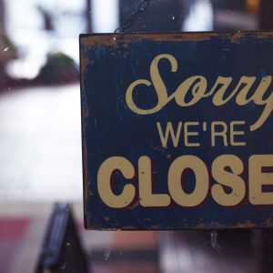 photo of a sign hanging that says Sorry We're Closed