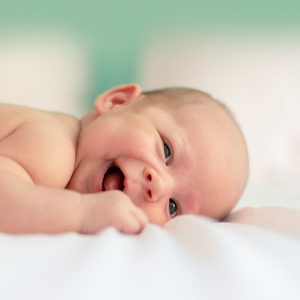 newborn baby smiling